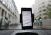 The Waze Inc.'s map-software is displayed on an Apple Inc. iPhone on an automobile windscreen in London