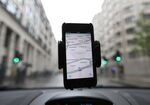 The Waze Inc.'s map-software is displayed on an Apple Inc. iPhone on an automobile windscreen in London