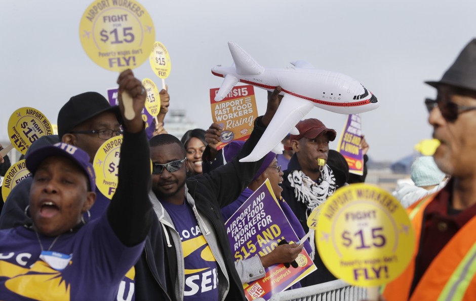 Airport workers rally for higher minimum wage in Detroit.