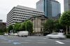 Vehicles travel past the Bank of Japan (BOJ) headquarters in Tokyo, Japan, on Monday, July 8, 2019. Governor Haruhiko Kuroda said extremely low interest rates will be kept in place until at least around next spring while the bank will keep an eye on risks for price momentum.