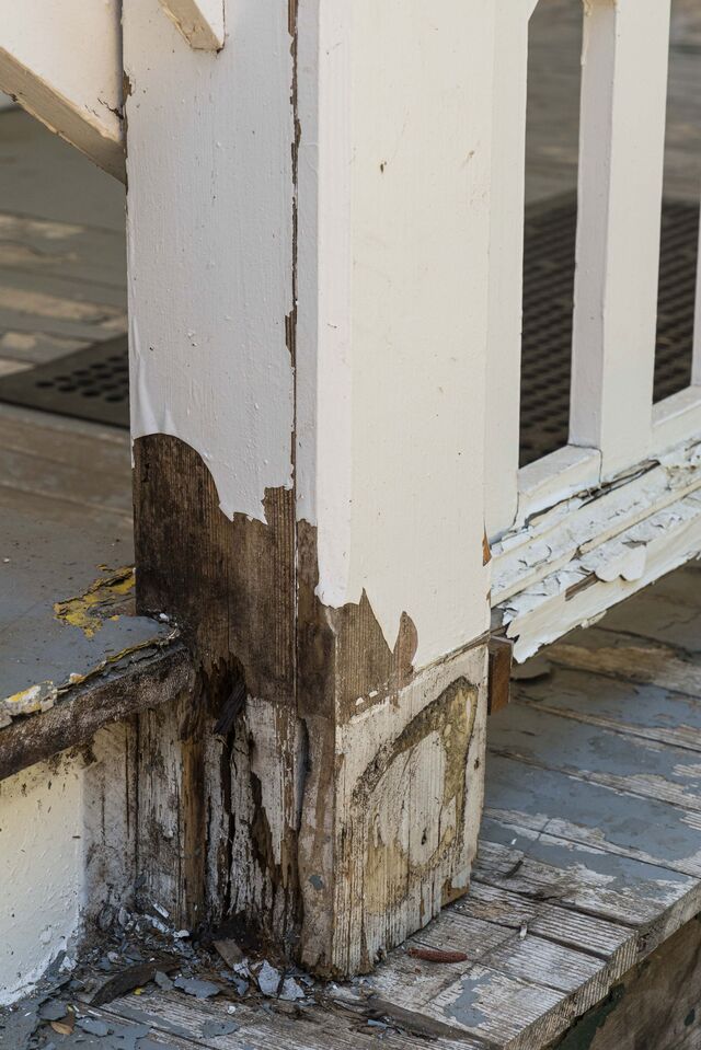 Chipped paint and wood rot on a deck and railing at the Wawona’s Washburn Cottage in July.
