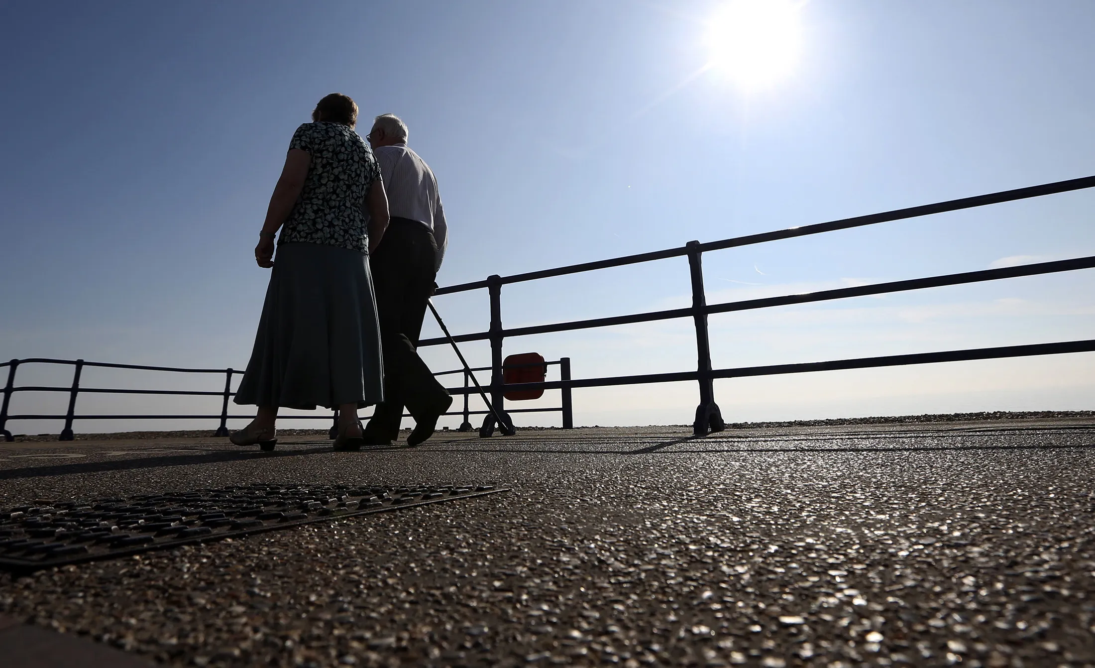 Pedestrians walk along the beachfront promenade in Eastbourne.&nbsp;