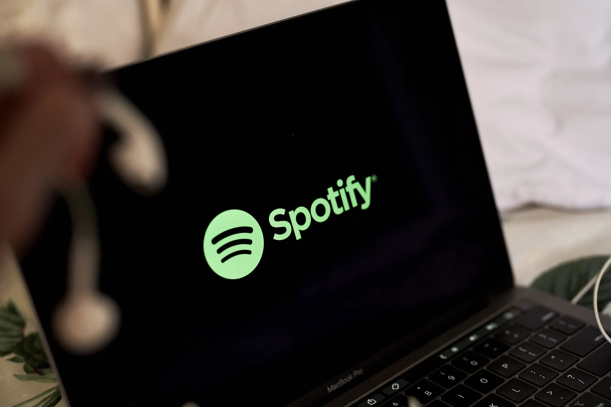 The Spotify logo on a laptop computer.