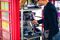 Umar Khalid, co-owner of the Kape Barako phone booth coffee stall, prepares an order, on Hampstead High Street, in London.