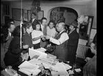 P.L. Prattis (center, in vest), an editor of the Pittsburgh Courier after Robert Lee Vann, in the newsroom with staff in the mid-1940s