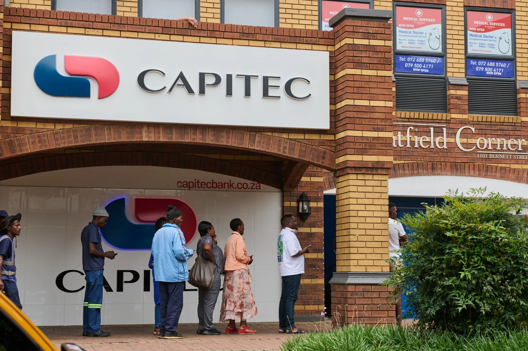 Customers queue near a Capitec ATM&nbsp;in Pretoria, South Africa.