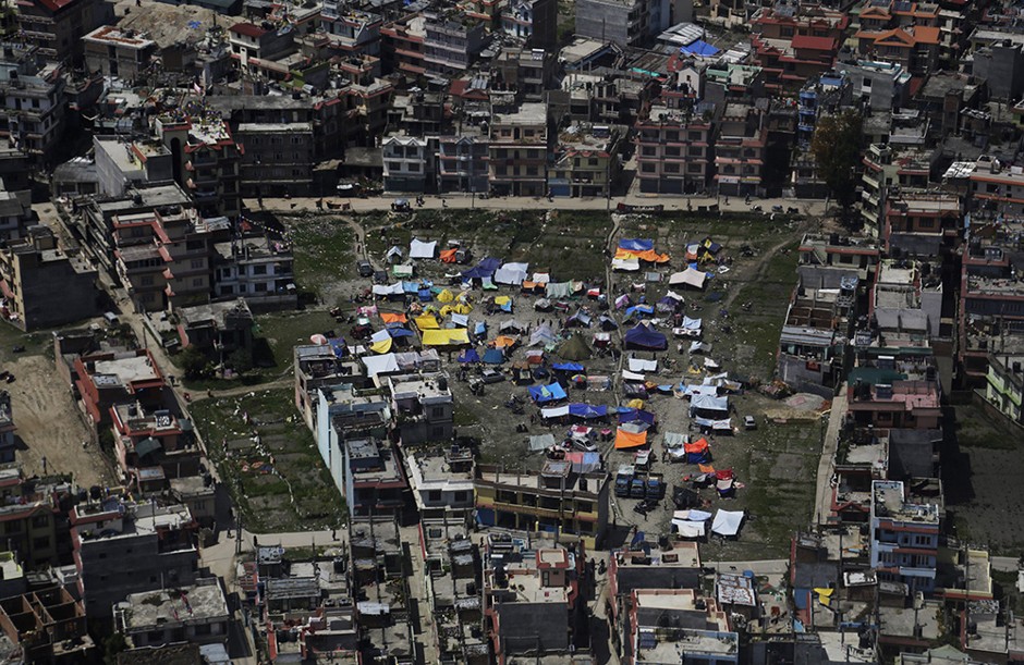 An aerial view of tents setup by residents in Kathmandu, Nepal, Monday, April 27, 2015. Shelter, fuel, food, medicine, power, news, workers — Nepal's earthquake-hit capital was short on everything Monday as its people searched for lost loved ones, sorted through rubble for their belongings and struggled to provide for their families' needs.