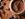 Cocoa powder in ceramic bowl with cocoa beans over brown texture background. Flat lay, close up.