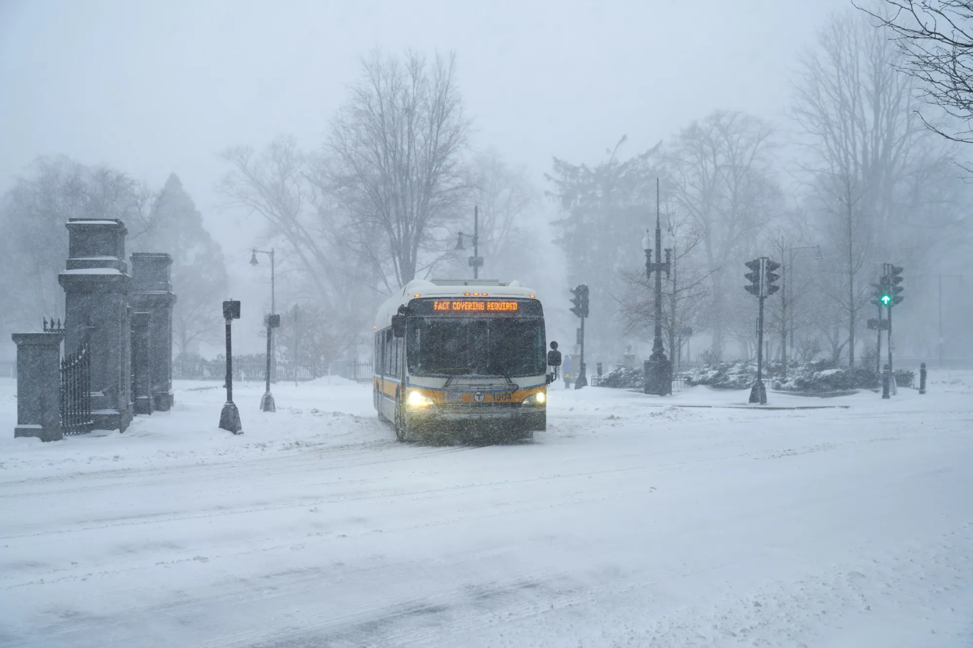 A city bus navigates a snow-covered street during a blizzard in Boston, Massachusetts, on Jan. 29.