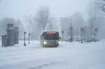 A city bus navigates a snow-covered street during a blizzard in Boston, Massachusetts, on Jan. 29.