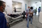 A patient rests on a bed in a hallway of the Rafic Hariri University Hospital (RHUH) in Lebanon's capital Beirut.