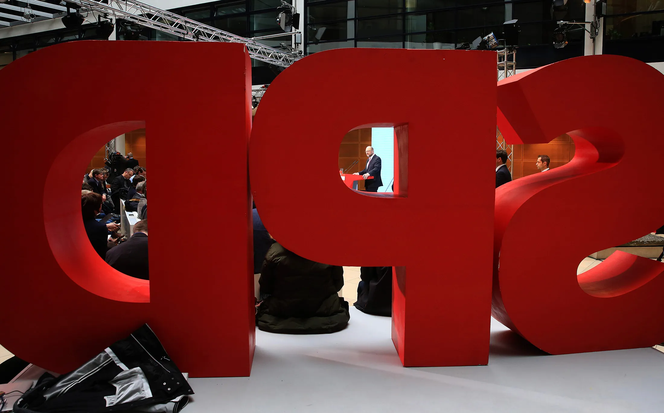 Martin Schulz, the Social Democrat Party (SDP) candidate for German Chancellor, center, is seen through the SPD logo while speaking during a news conference at the SPD headquarters in Berlin, Germany, on Monday, Jan. 30, 2017. Schulz, 61, who last month stepped down as president of the European Parliament to join the German political fray, was hoisted to the Social Democratic candidacy after party leader Sigmar Gabriel surprised rank-and-file members by stepping aside.
