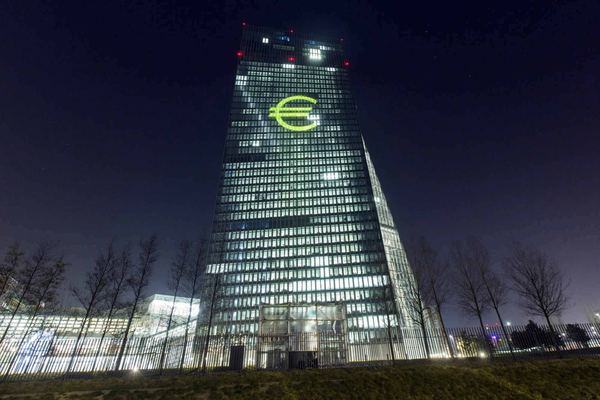 An illuminated euro currency symbol is projected on to the European Central Bank (ECB) headquarters during the Luminale light festival in Frankfurt, Germany, on Thursday, March 17, 2016. European government bonds climbed after the Federal Reserve signaled that it will raise interest rates at a slower pace than previously estimated, bolstering demand for fixed-income securities around the world.