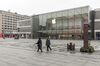 Pedestrians wearing a face masks walk through an empty shopping plaza, in view of a closed Apple Inc. store, in Hangzhou, China, on Tuesday, Feb. 11, 2020. The death toll from the coronavirus climbed above 1,000, as the Chinese province at the epicenter of the outbreak reported its highest number of fatalities yet.