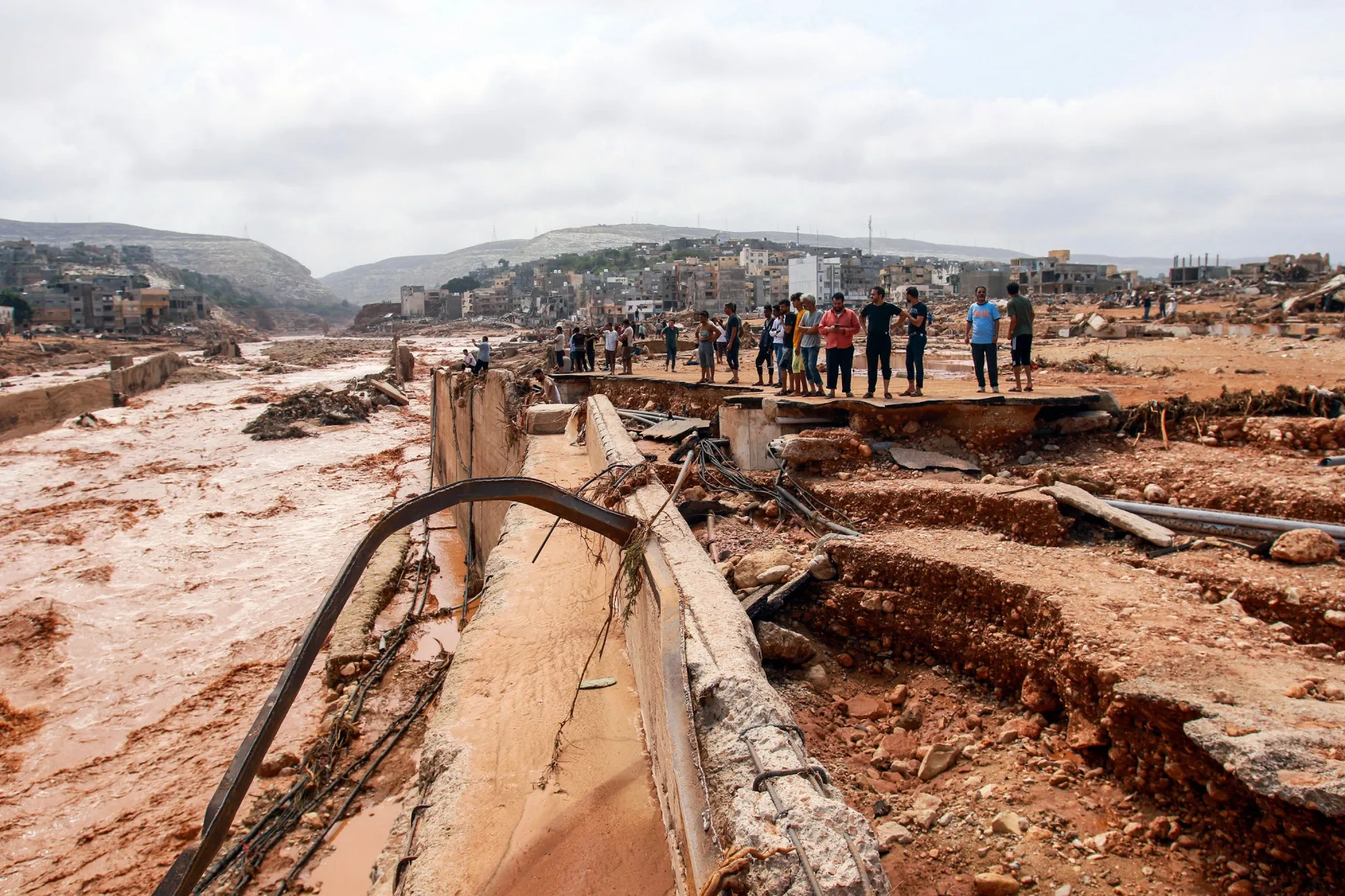 People look at the damage caused by severe flooding in Libya in September 2023.&nbsp;