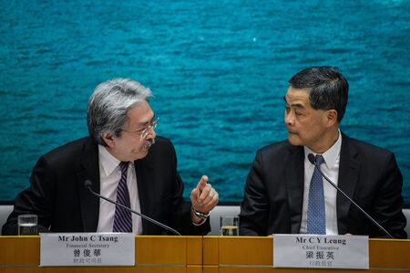 Hong Kong Chief Executive Leung Chun-ying listens to Financial Secretary John Tsang during a news conference in Hong Kong on November 4, 2016.