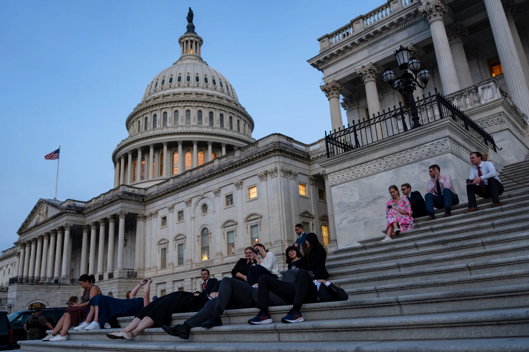 Senate staff and members of the media on the Senate steps during sunrise at the US Capitol in Washington, DC.&nbsp;