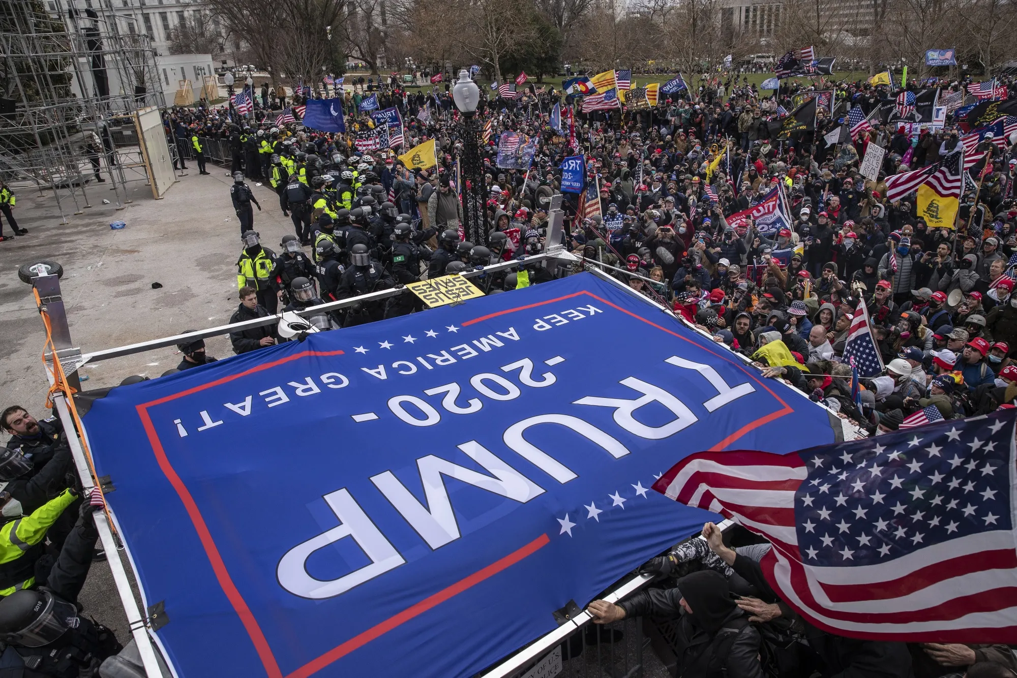 A "Trump 2020" banner is carried as rioters&nbsp;swarm the U.S. Capitol on Jan. 6.&nbsp;