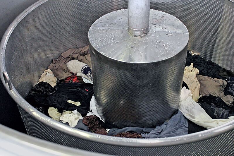 Discarded clothing is fed into a machine at JeplanΆs Tokyo plant