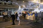 Demonstrators stand in a cloud of tear gas during a protest in the Sheung Wan district of Hong Kong, July 28.