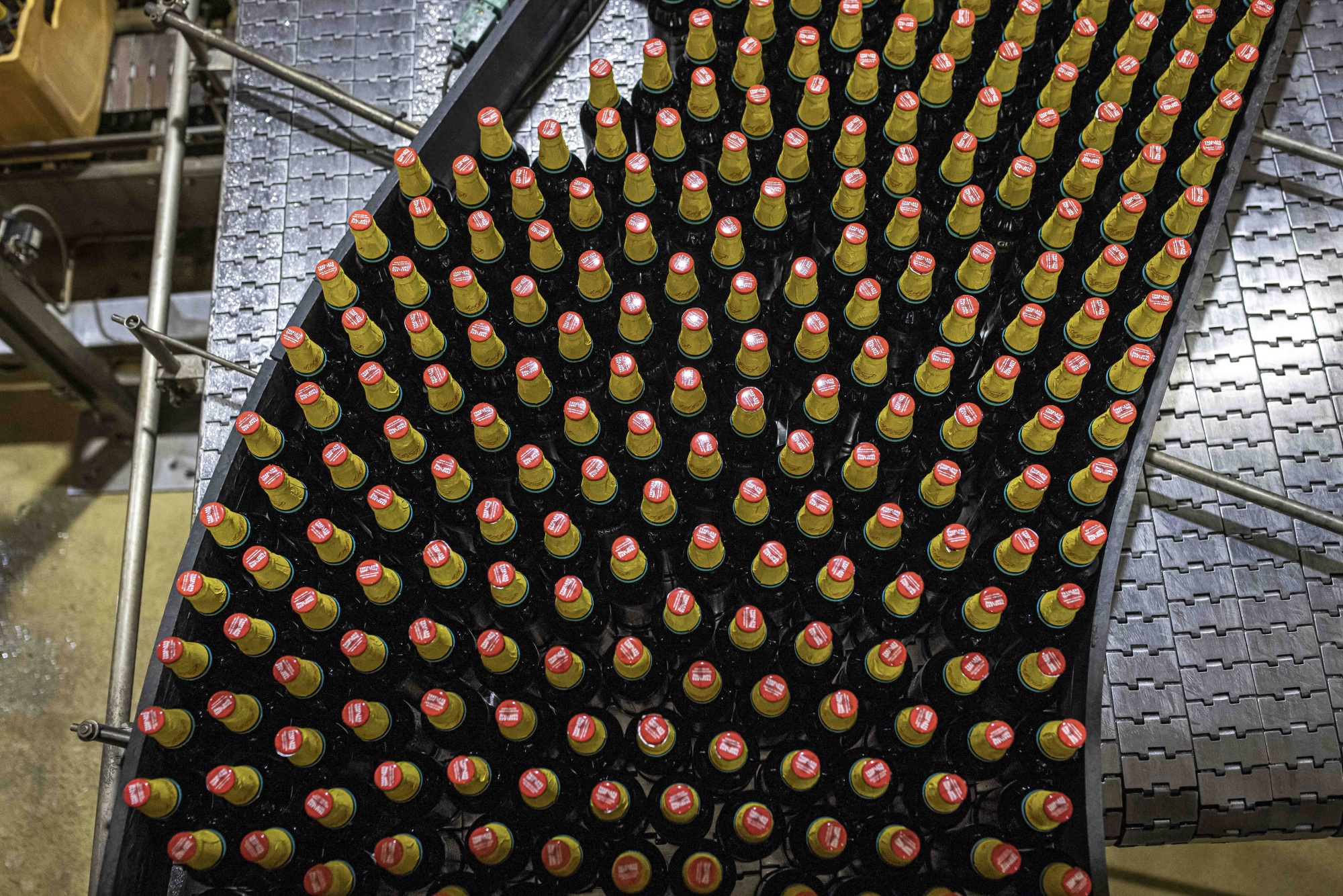 Bottles of Guinness move along a conveyor at a bottling plant&nbsp;operated by East Africa Breweries&nbsp;in Nairobi.