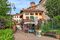Narrow street among houses with flowers in town of Barolo in Piedmont, Northern Italy.