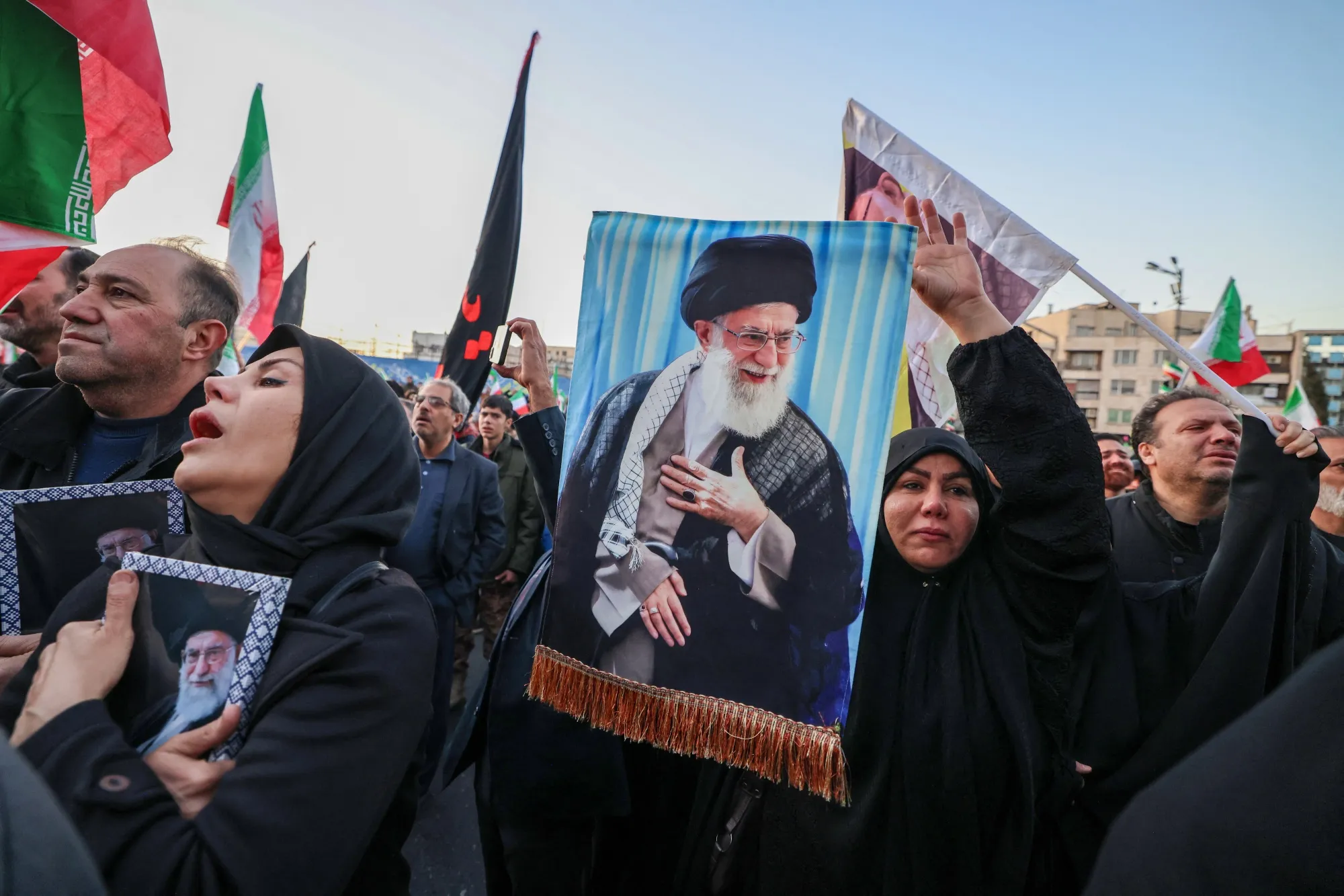 Mourners hold a portrait of Ayatollah Ali Khamenei in Tehran on March 1, following the news of his death.