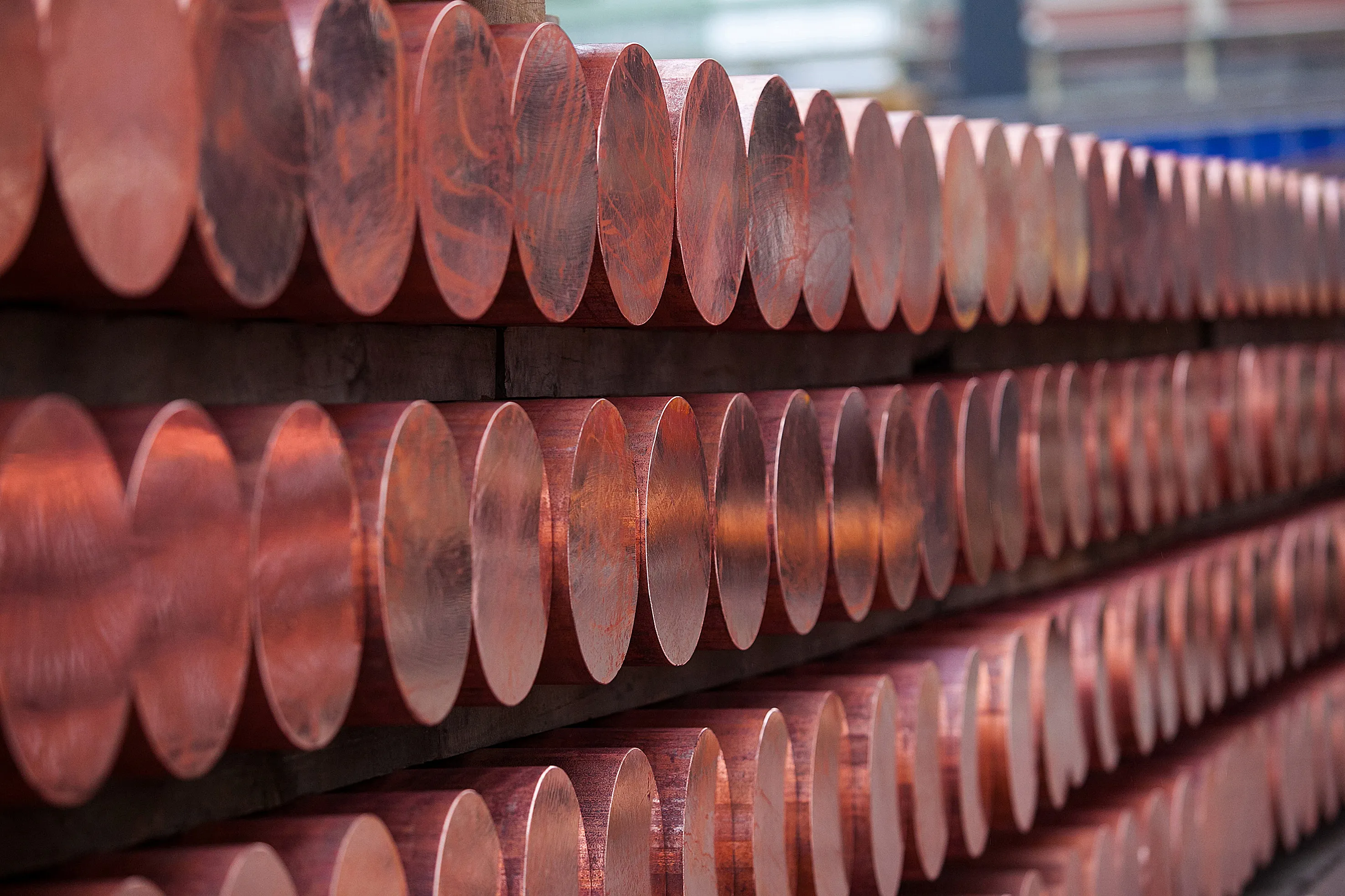 Copper rods sit stored on racks after being solidified by the continuous casting process at the Aurubis AG headquarters in Hamburg, Germany. Copper for delivery in three months fell as much as 1.9 percent to $6,230.75 a metric ton on the London Metal Exchange, the lowest since June 2010, and traded at $6,237.