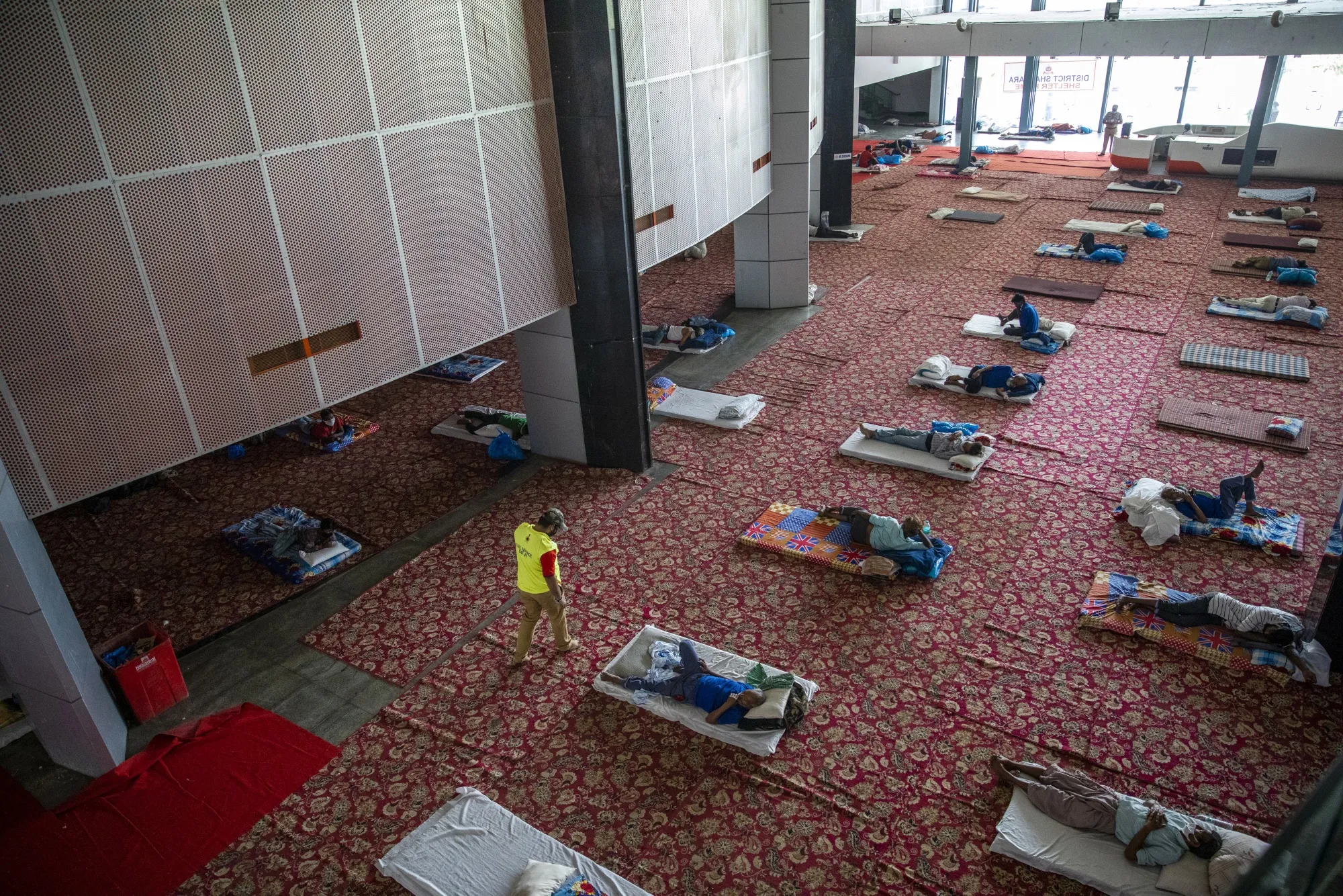 People rest at a temporary shelter set up at the Yamuna Sports Complex during a lockdown imposed due to the coronavirus in New Delhi on April 15.