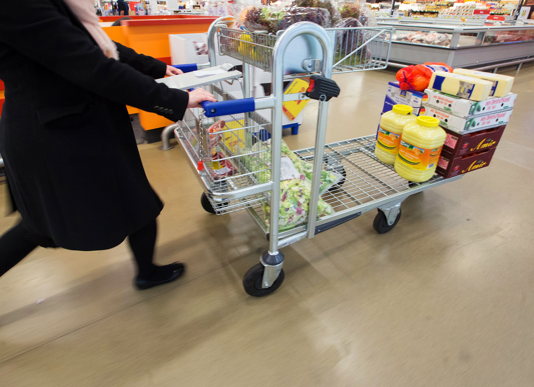 A customer pushes a shopping cart inside a Metro AG wholesale store in Duesseldorf.
