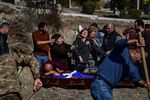 A mother mourns above the coffin of her child, killed during fighting over the breakaway region of Nagorno-Karabakh, in Stepanakert on Oct. 17.