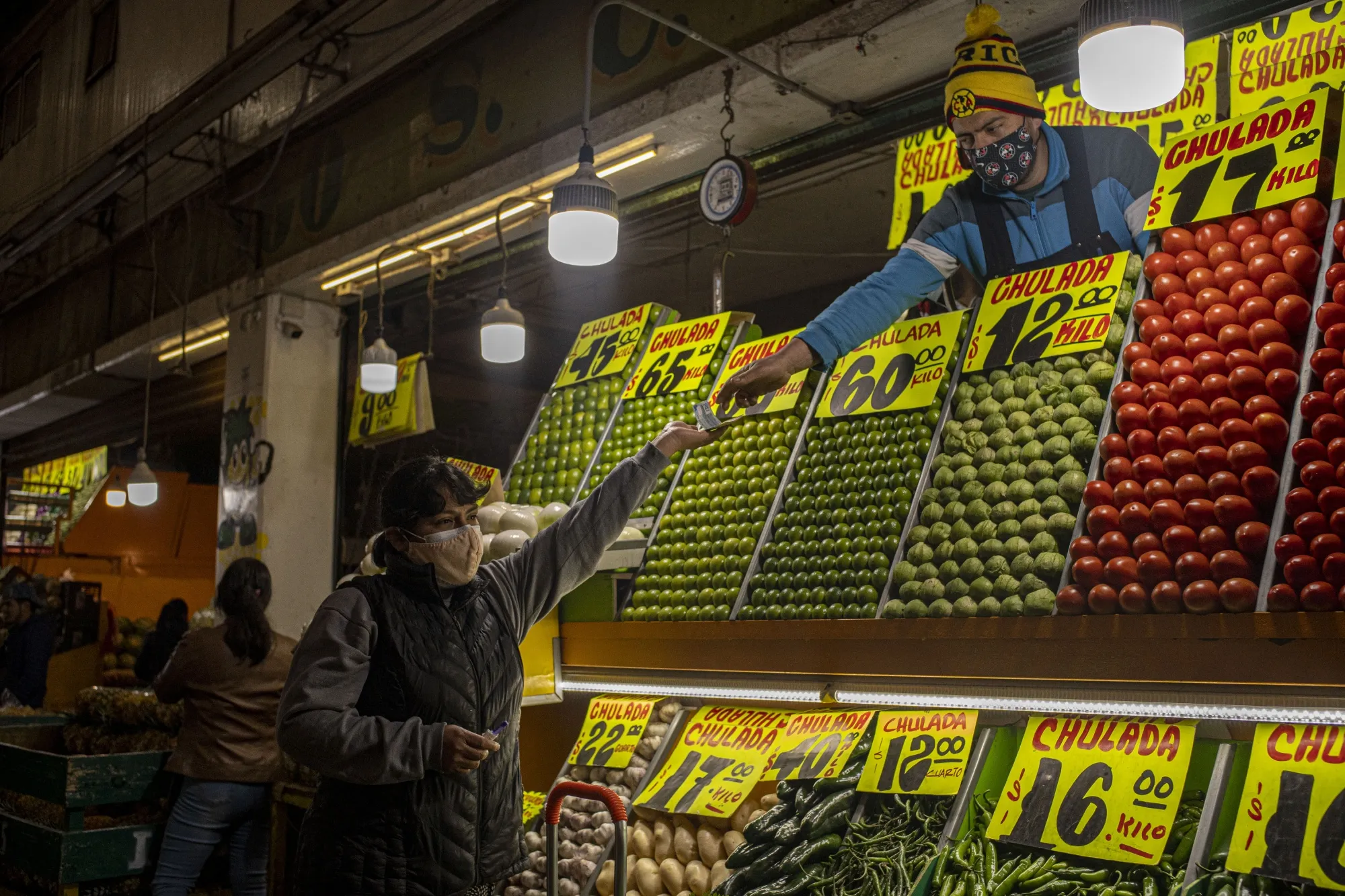A shopper purchases vegetables&nbsp;at the Central de Abastos Market in Mexico City, Mexico.