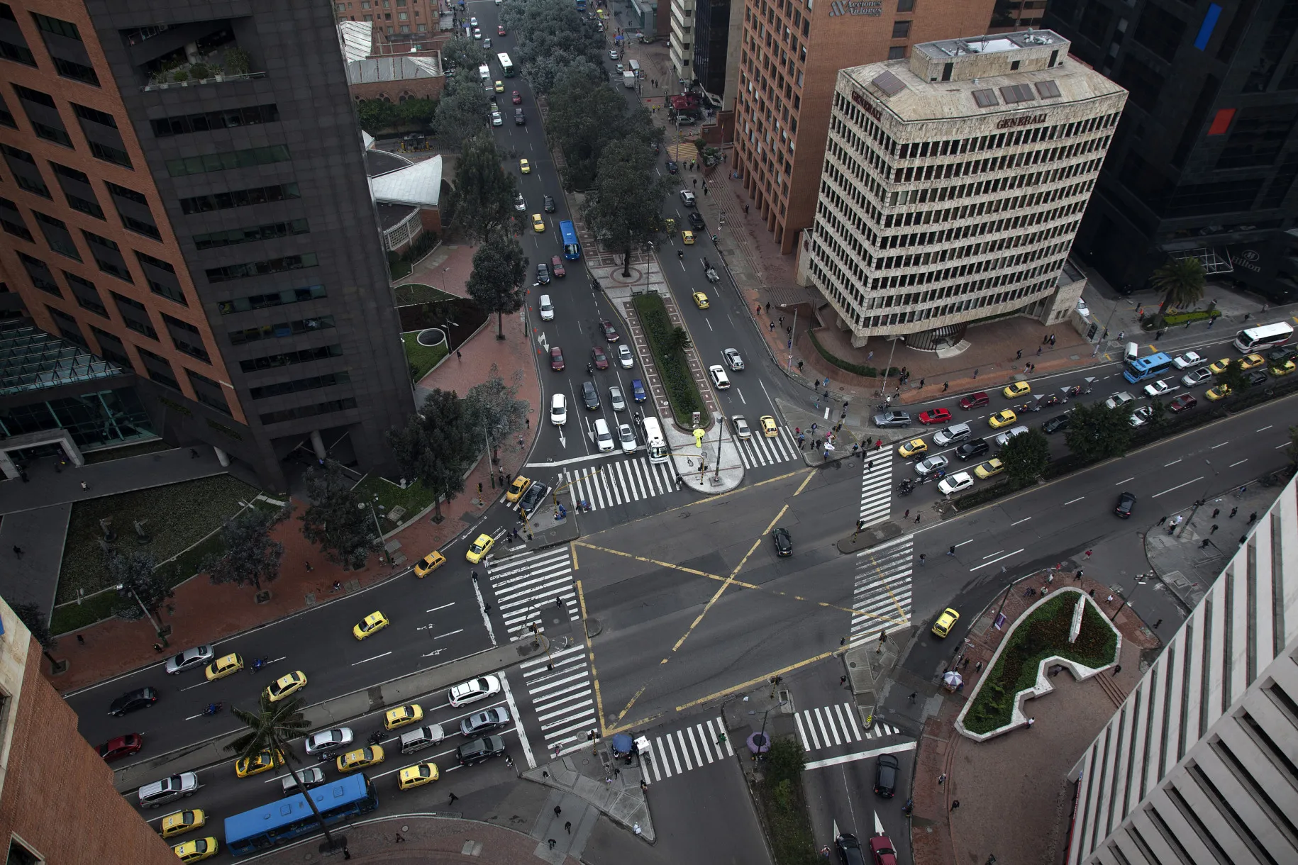 Vehicles pass through an intersection in the financial district of Bogota.