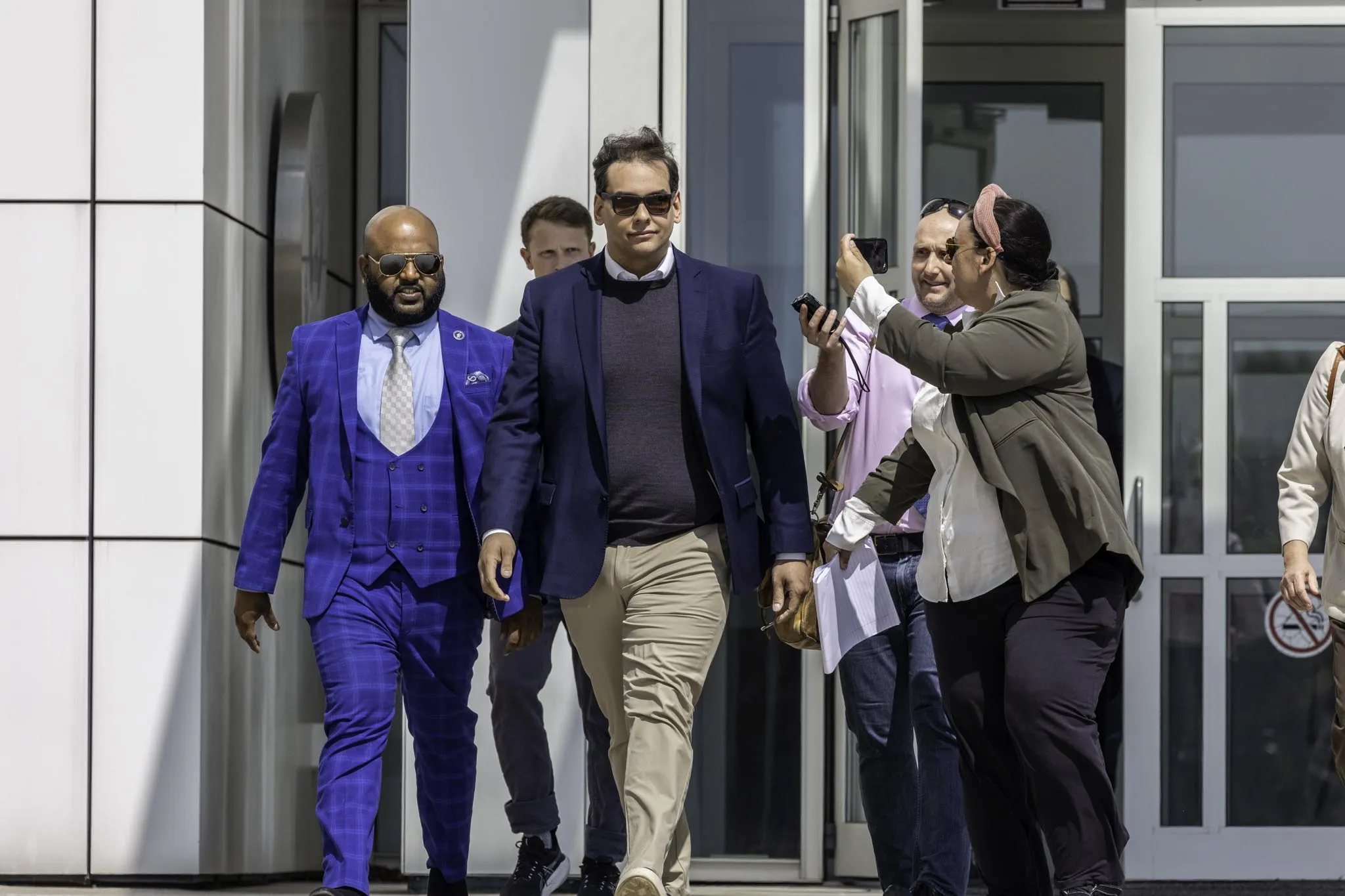 George Santos, center, departs federal court in Central Islip, New York, on&nbsp;May 5.