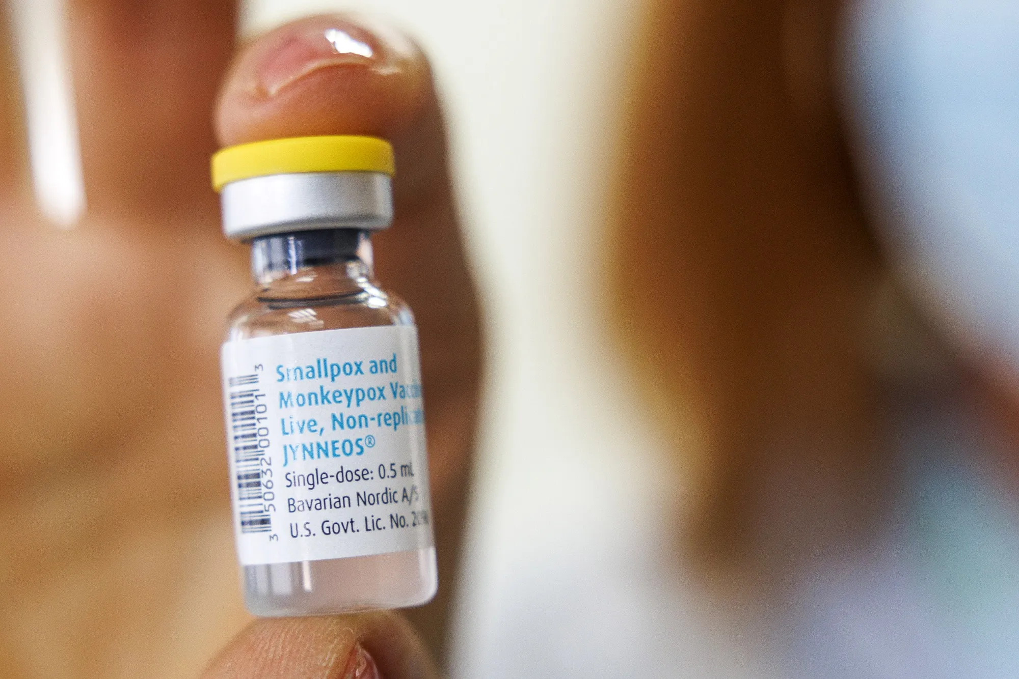 A health worker handles a vial of&nbsp;the monkeypox vaccine.
