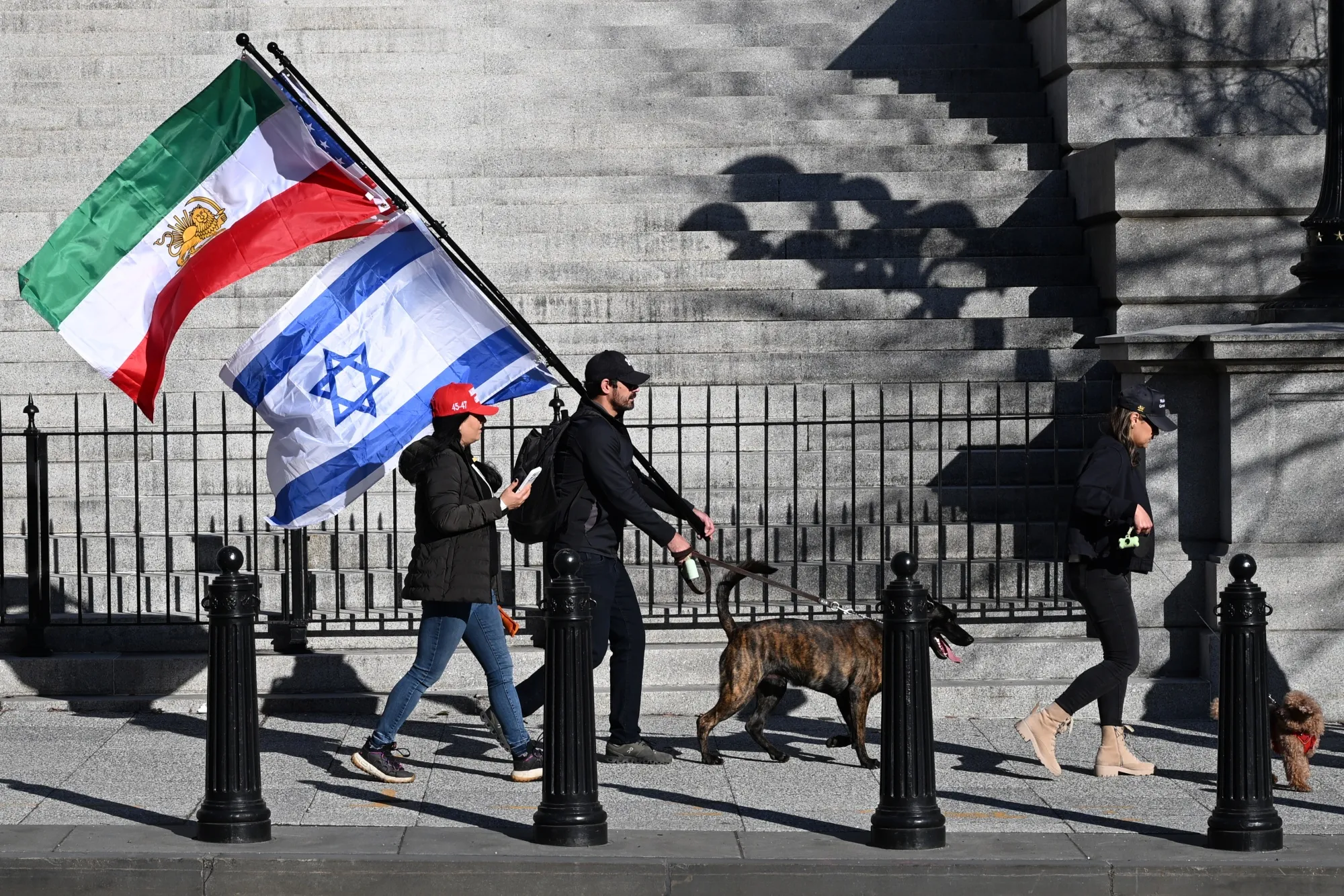 A demonstrator carries Israeli and Iranian lion and sun flags in Washington on March 7.