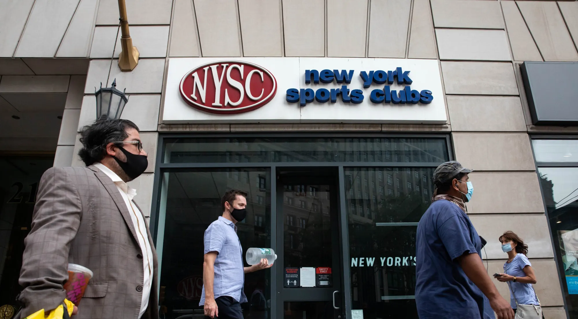 Pedestrians pass in front of a New York Sports Club gym in New York, U.S., on&nbsp;Sept. 14.
