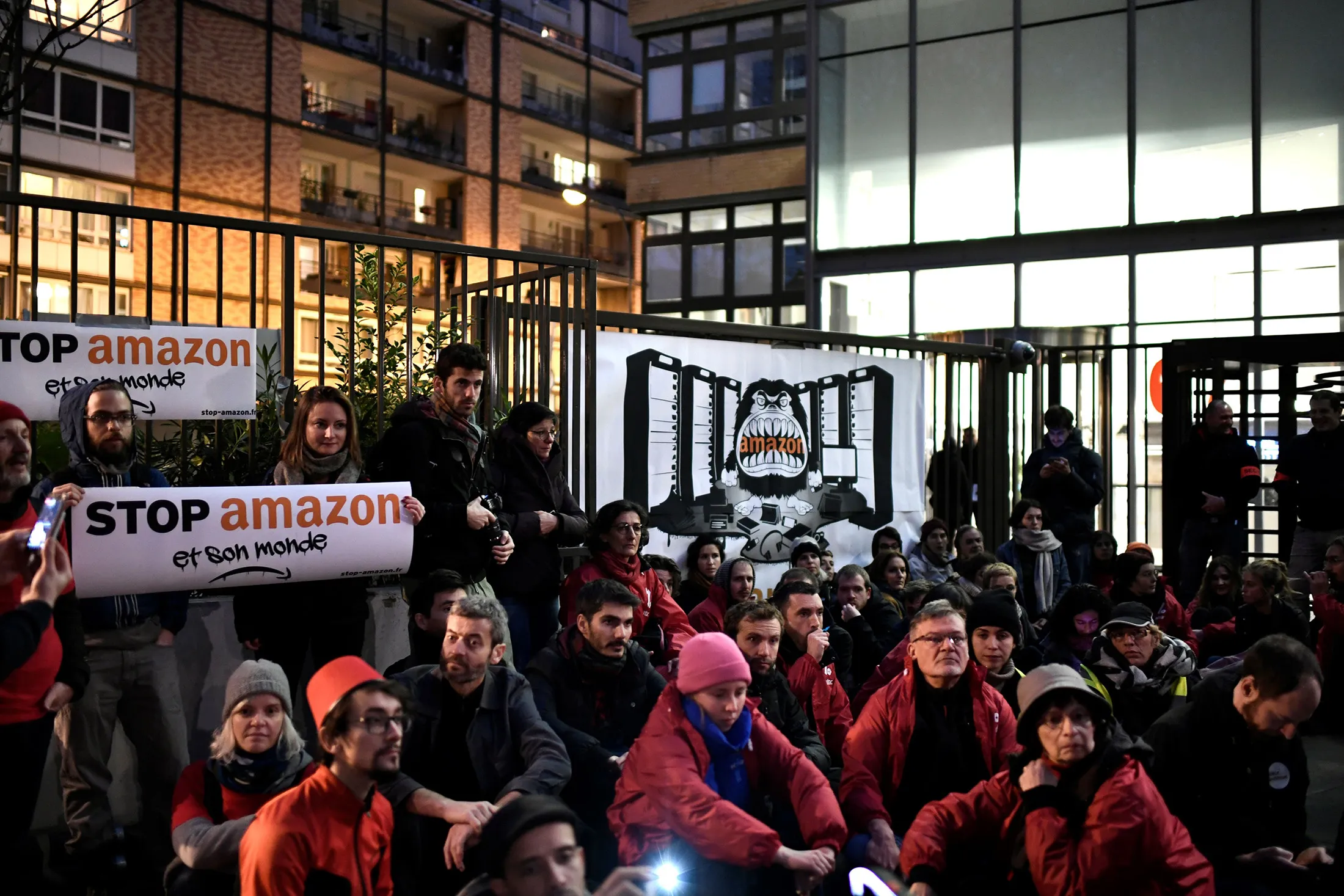 Demonstrators sit during a protest outside the Amazon France headquarters in Clichy&nbsp;on Nov. 29.