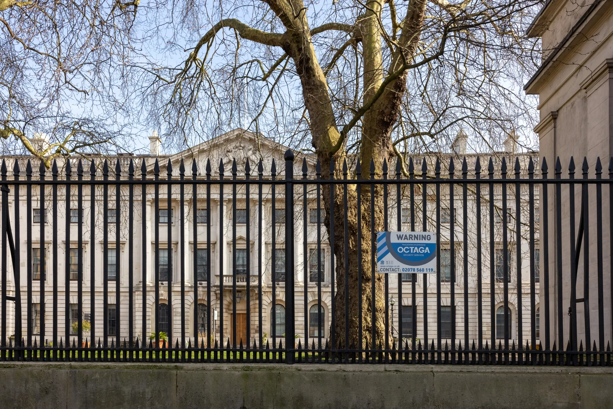 A boundary fence outside the Royal Mint Court office complex, the possible future site of a new Chinese Embassy in London.