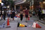 People move around the debris of roadblocks set by protesters during a protest against a planned national security law in the Wan Chai district in Hong Kong, China, on Sunday, May 24, 2020.