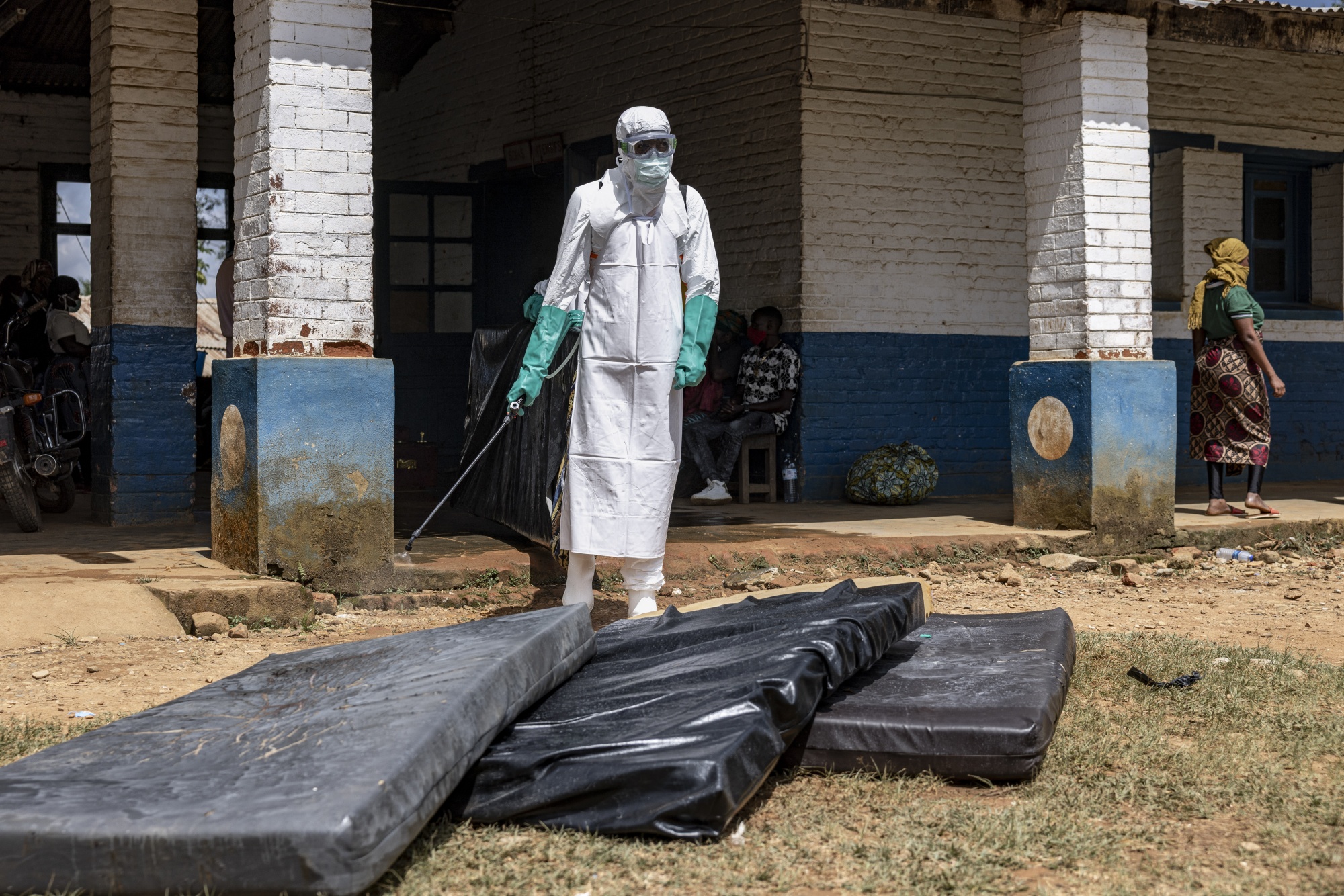 Health workers wearing protective equipment disinfect mattresses outside the General Referral Hospital during the Ebola outbreak response in Mongbwalu, Democratic Republic of Congo on May 21. Photographer: Michel Lunanga/Getty Images