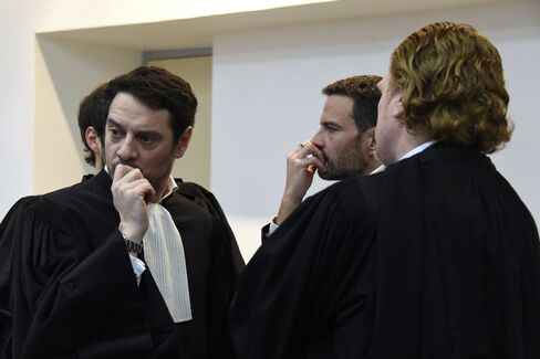 Jerome Kerviel, center, stands with his lawyer David Koubbi, left, at court in Versailles, on Wednesday, Jan. 20.