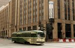 A street car makes its way past the corporate headquarters of Twitter in San Francisco.