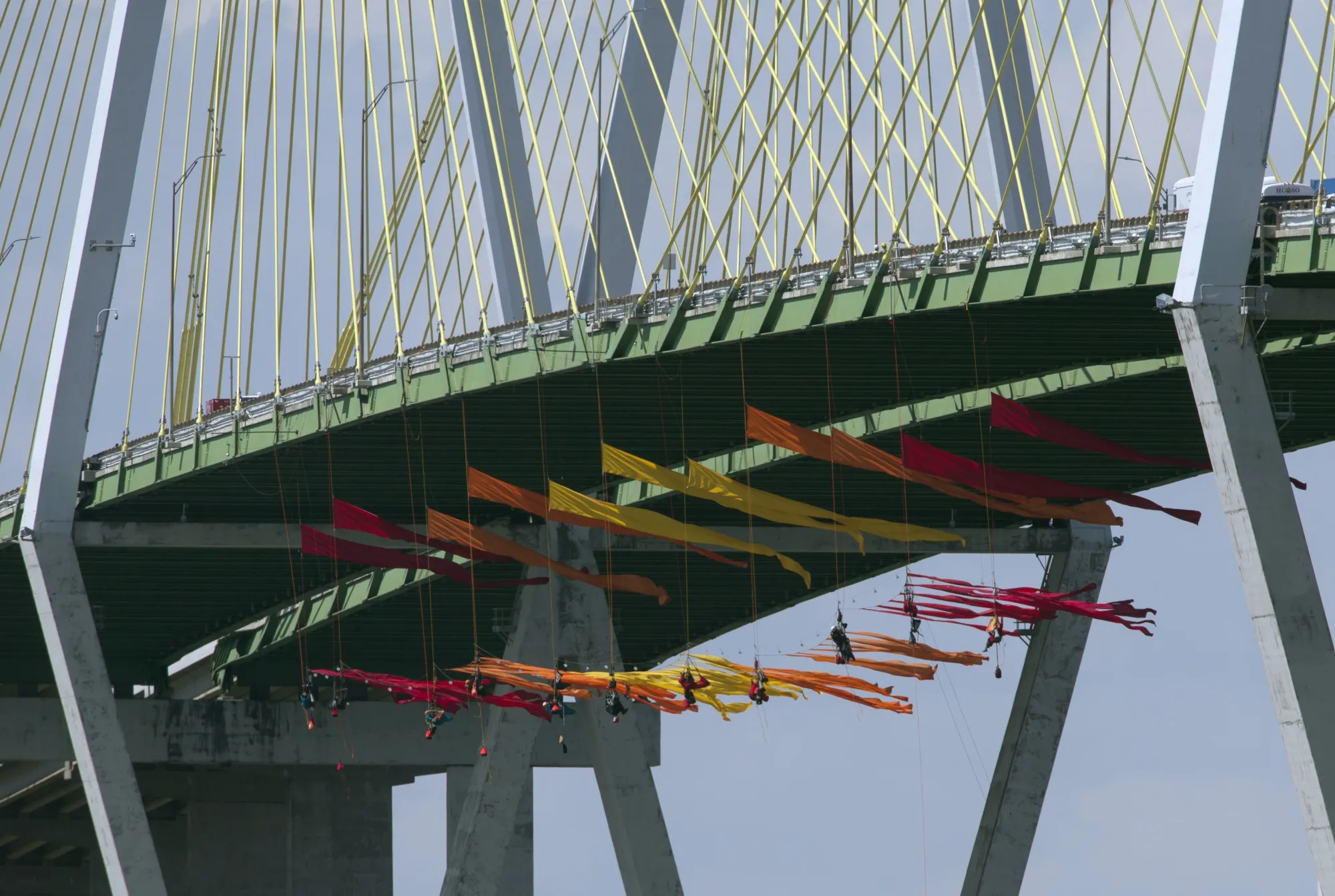 Greenpeace protesters dangle from the Fred Hartman Bridge, Sept. 12.