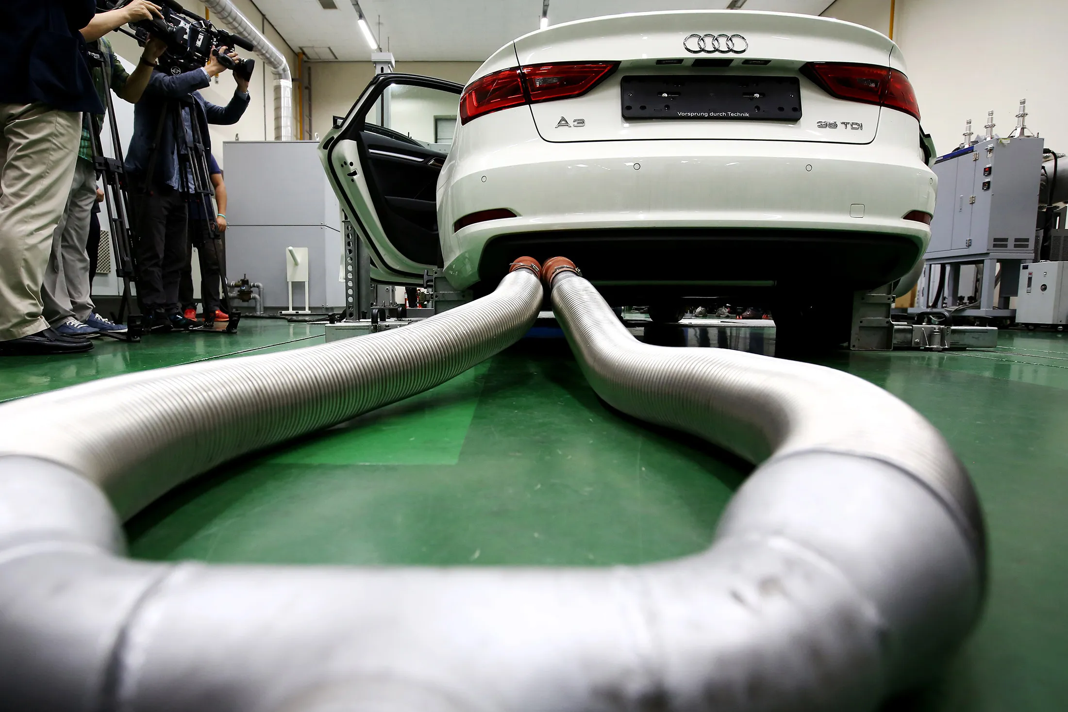 Members of media film an Audi AG A3 35 TDI emissions certification vehicle, produced by Volkswagen AG, waiting to be tested inside the Transportation Pollution Research Center laboratory, operated by National Institute of Environmental Research in Incheon, South Korea, on Thursday, Oct. 1, 2015.
