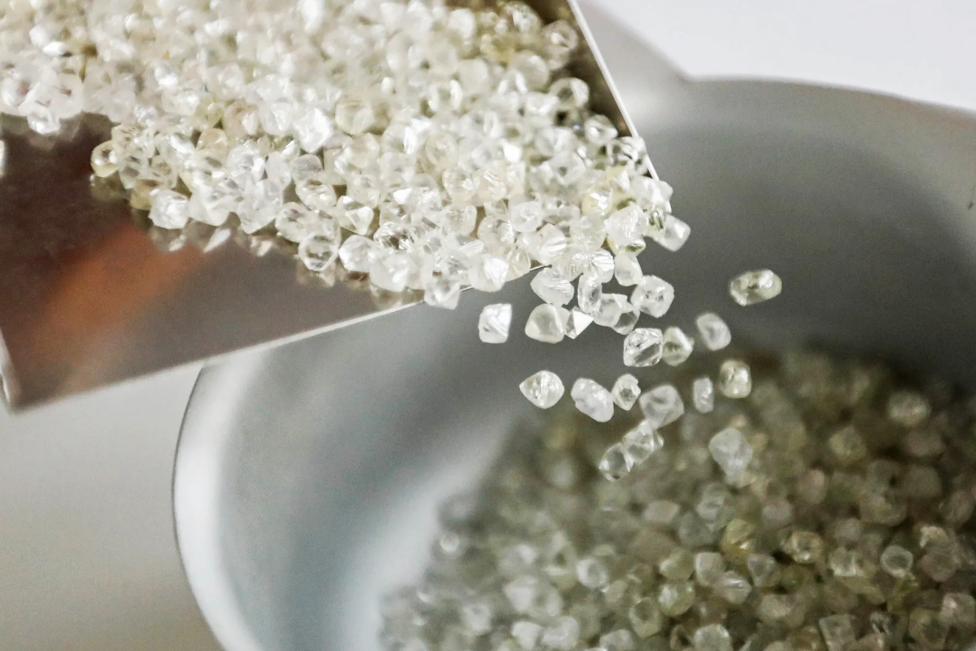 An employee handles rough diamonds at the ICG rough diamonds trader's office in the diamond district of Antwerp, Belgium, on Thursday, July 20, 2017. An ugly year for diamonds in the vital U.S. market is piling pressure on Europe’s historic center of the $80 billion global trade.
