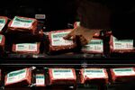 A customer picks up a package of Impossible Burger plant based meat at a grocery store in Los Angeles, California.
