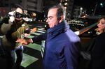 Former Nissan Chairman Carlos Ghosn and his wife Carole walks past members of the press as they arrive at their residence in Tokyo on April 3, 2019.