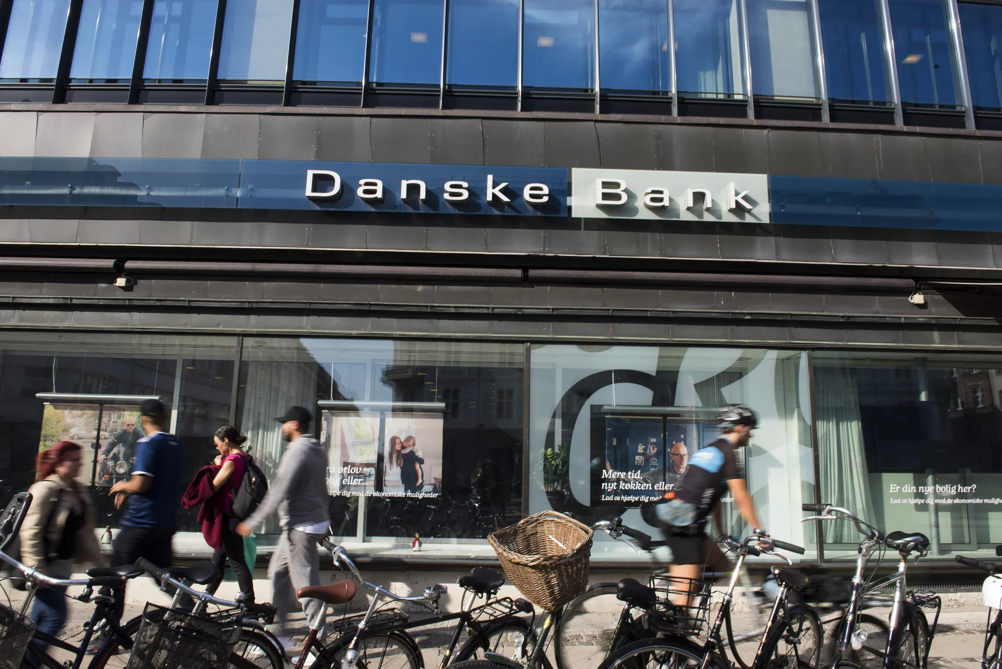Pedestrians walk past a Danske Bank A/S bank branch in Copenhagen, Denmark.