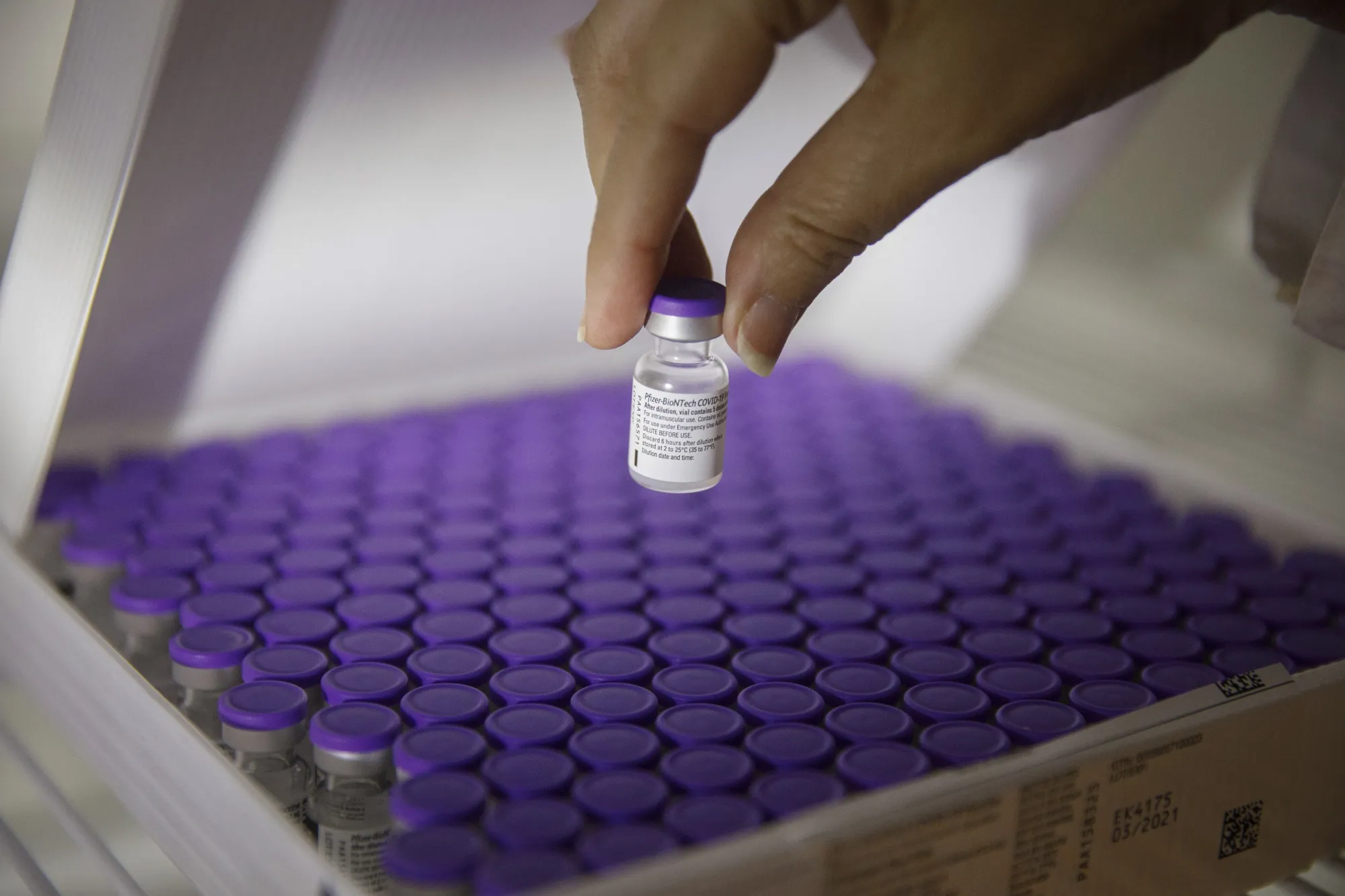 A nurse handles a vial of the the Pfizer-BioNTech Covid-19 vaccine in Holon, Israel.
